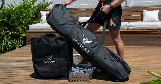 A portable woodfired steam sauna kit including carry bags and man holding handles