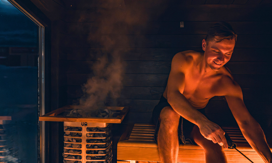 Man enjoying Soulfire portable woodfired sauna in Australian backyard for health and relaxation benefits.